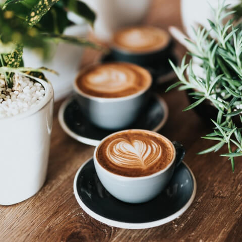 three espresso cafe cups aligned